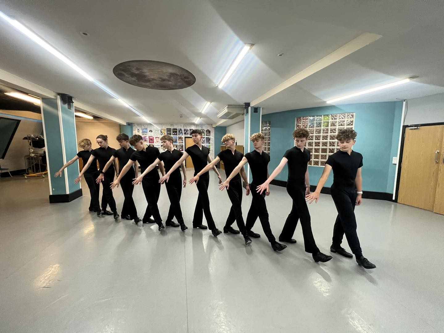 A group of teenage boys in black outfits posing at Starlight Dance and Musical Theatre School