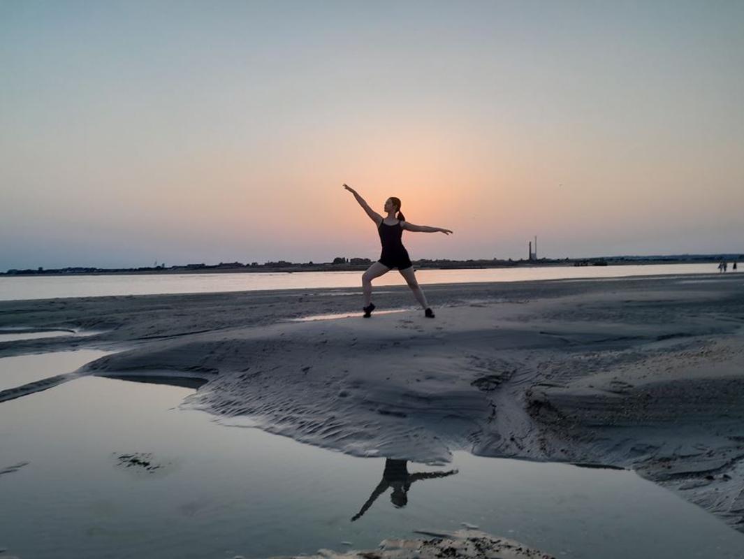 Emma Jones dancing on the beach