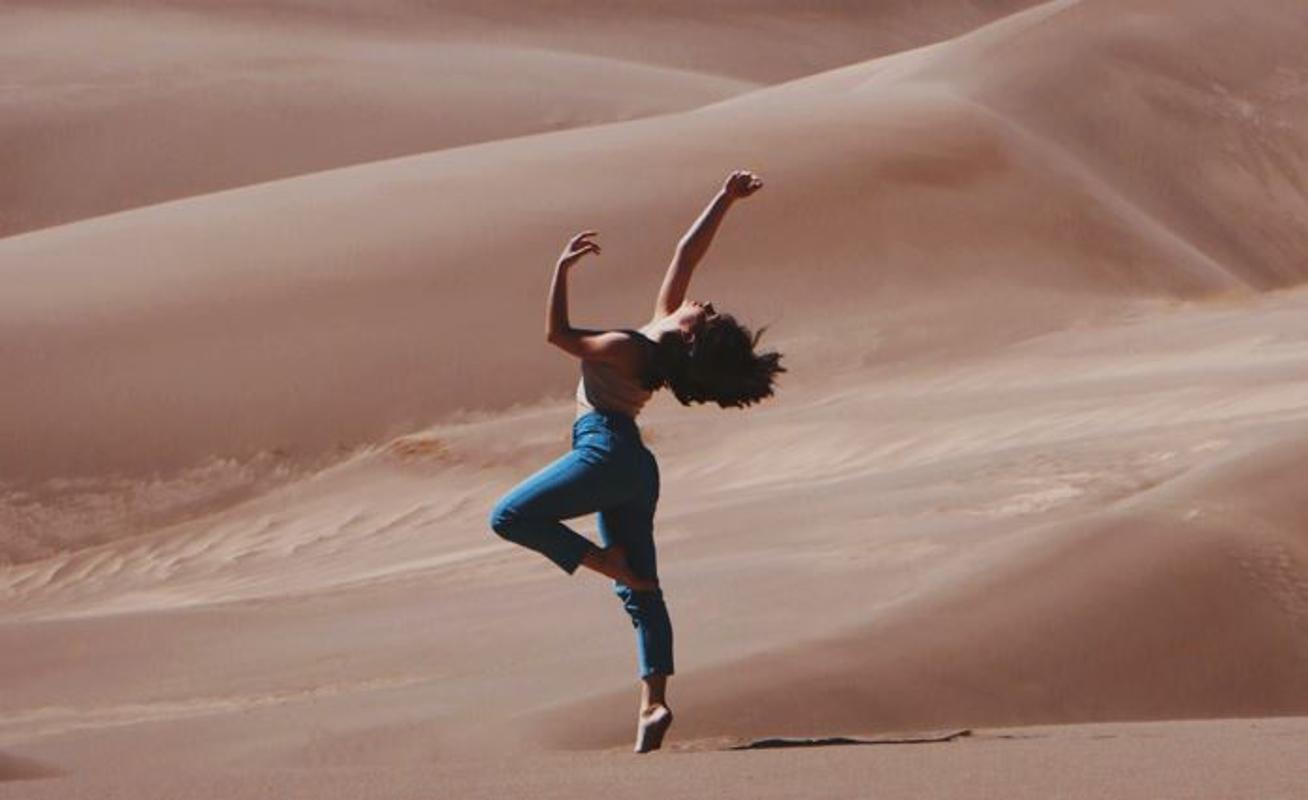 Woman dancing in desert