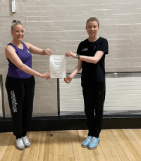 Tap dance students in studio with certificate