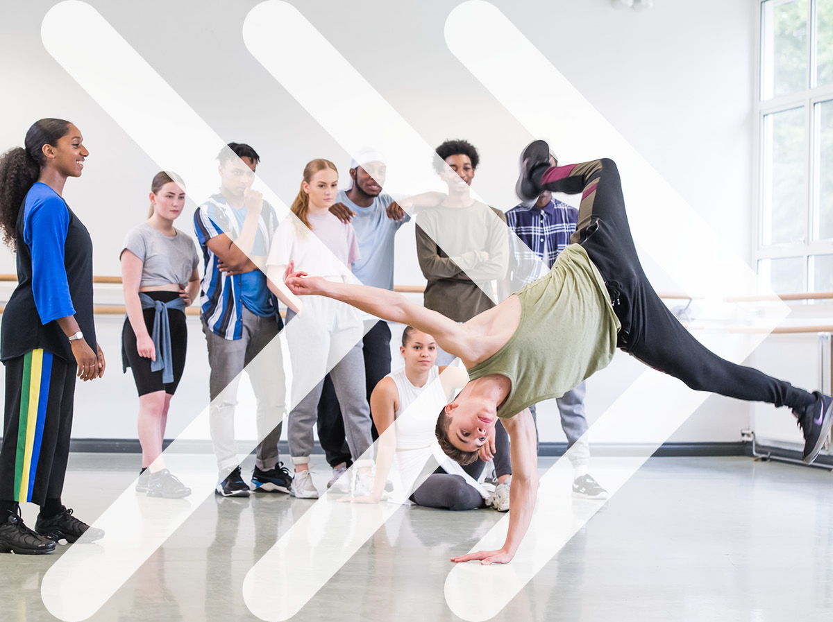 An ISTD student mid-breaking, ISTD chevrons imposed into the background.