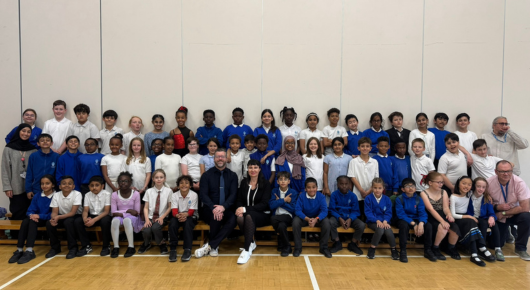Group of school children with teachers on a bench